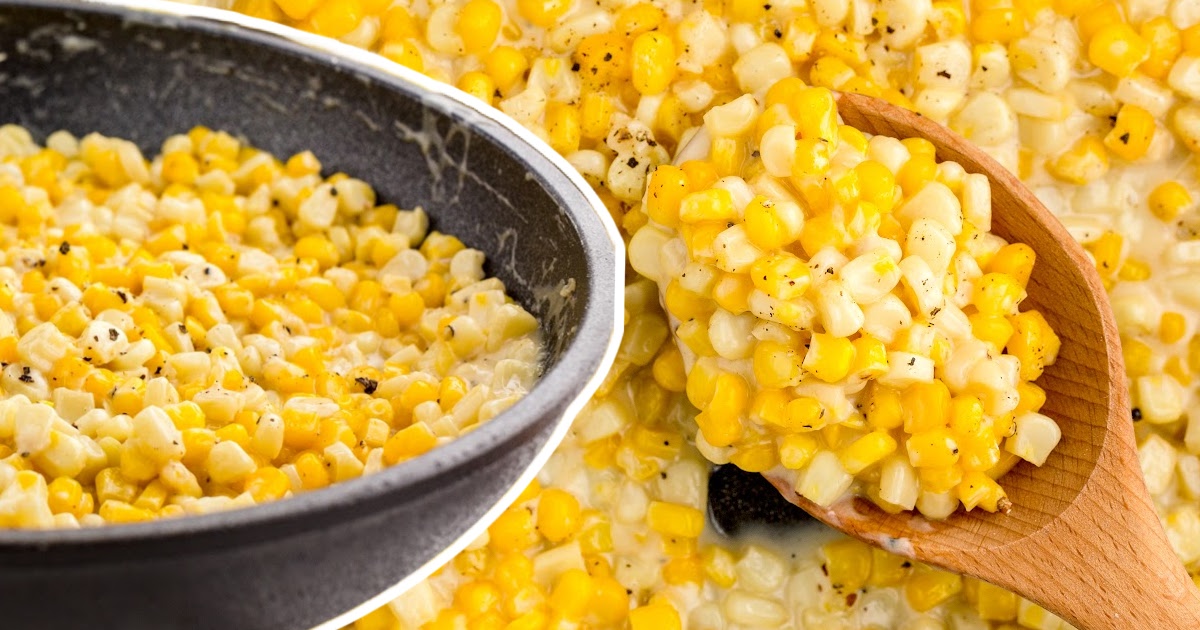 Honey Butter Skillet Corn in a bowl and a wooden spoon holding some