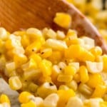 a wooden spoon holding some Honey Butter Skillet Corn