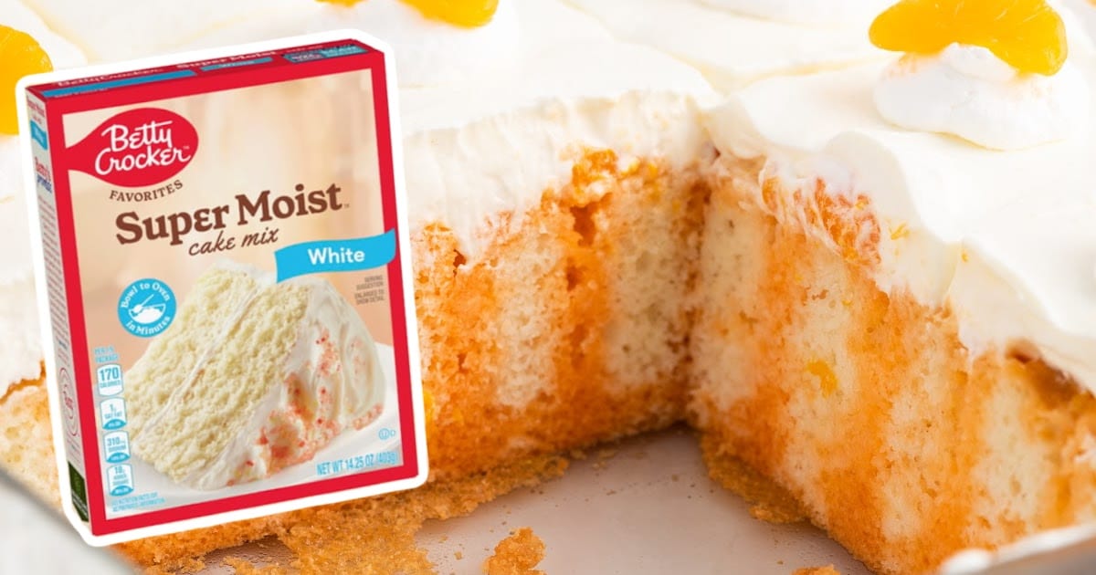 Orange Creamsicle Poke Cake with a piece missing