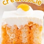 a piece of Orange Creamsicle Poke Cake on a plate