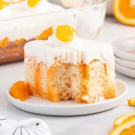 a piece of Orange Creamsicle Poke Cake