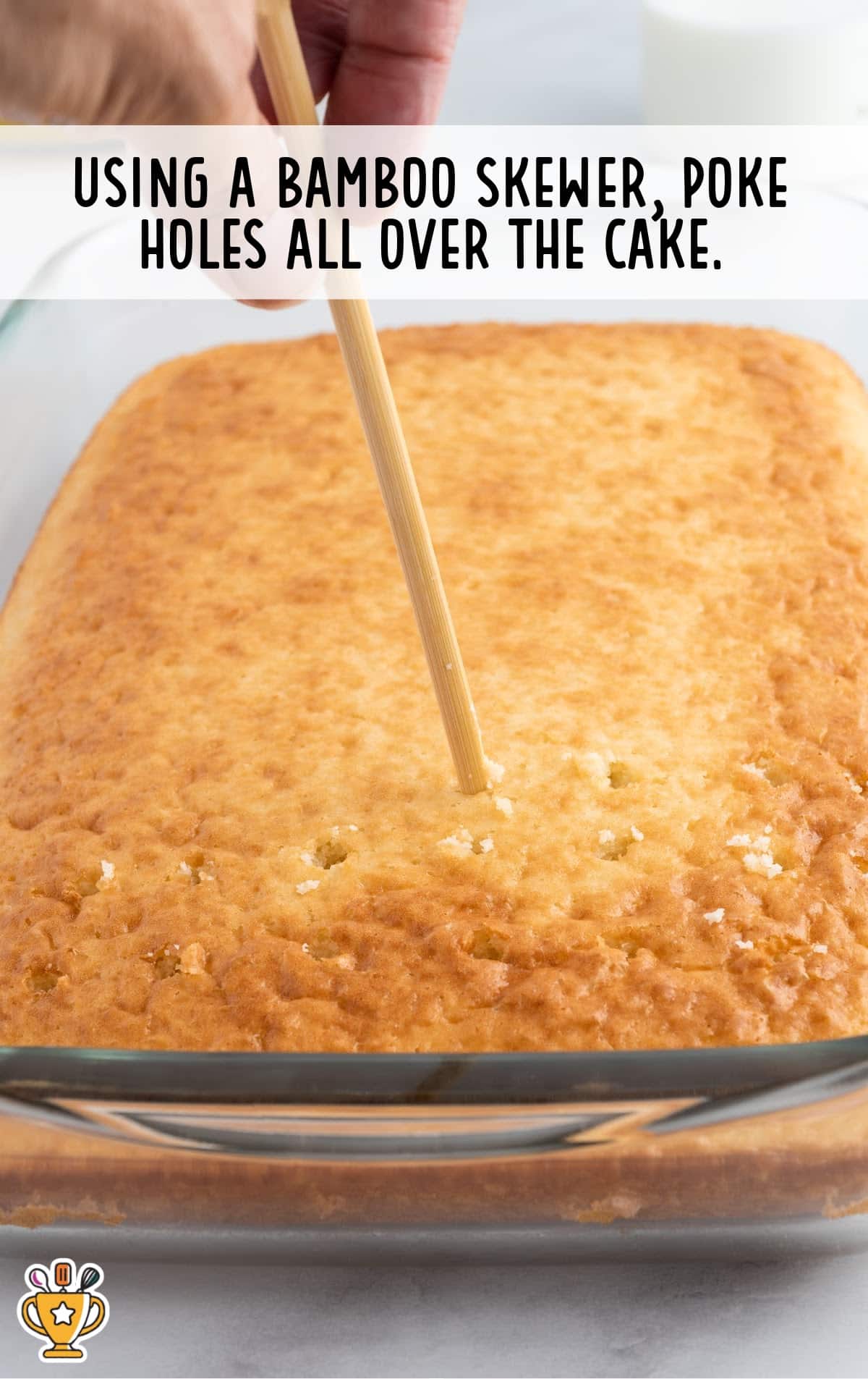 bamboo skewer poking holes all over the cake