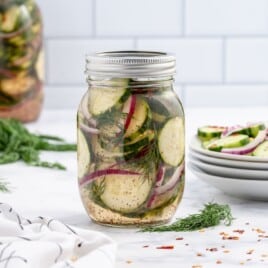 Recipe card showing ingredients and steps to make pickled cucumber salad in a mason jar