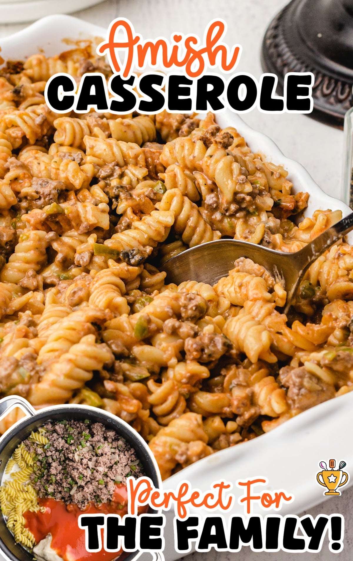 Baked Amish casserole in a dish with a serving spoon lifting a portion, showcasing creamy pasta and ground beef filling.