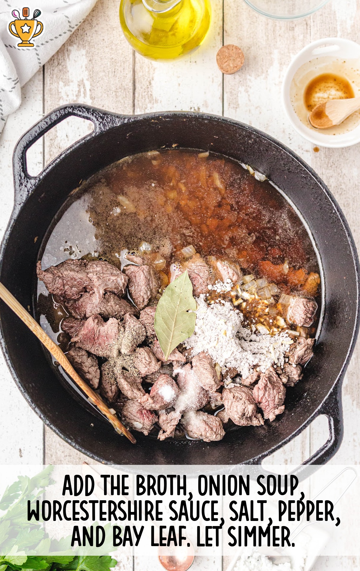 Ingredients including broth, onion soup mix, Worcestershire, and seasonings added to the skillet with cooked beef.