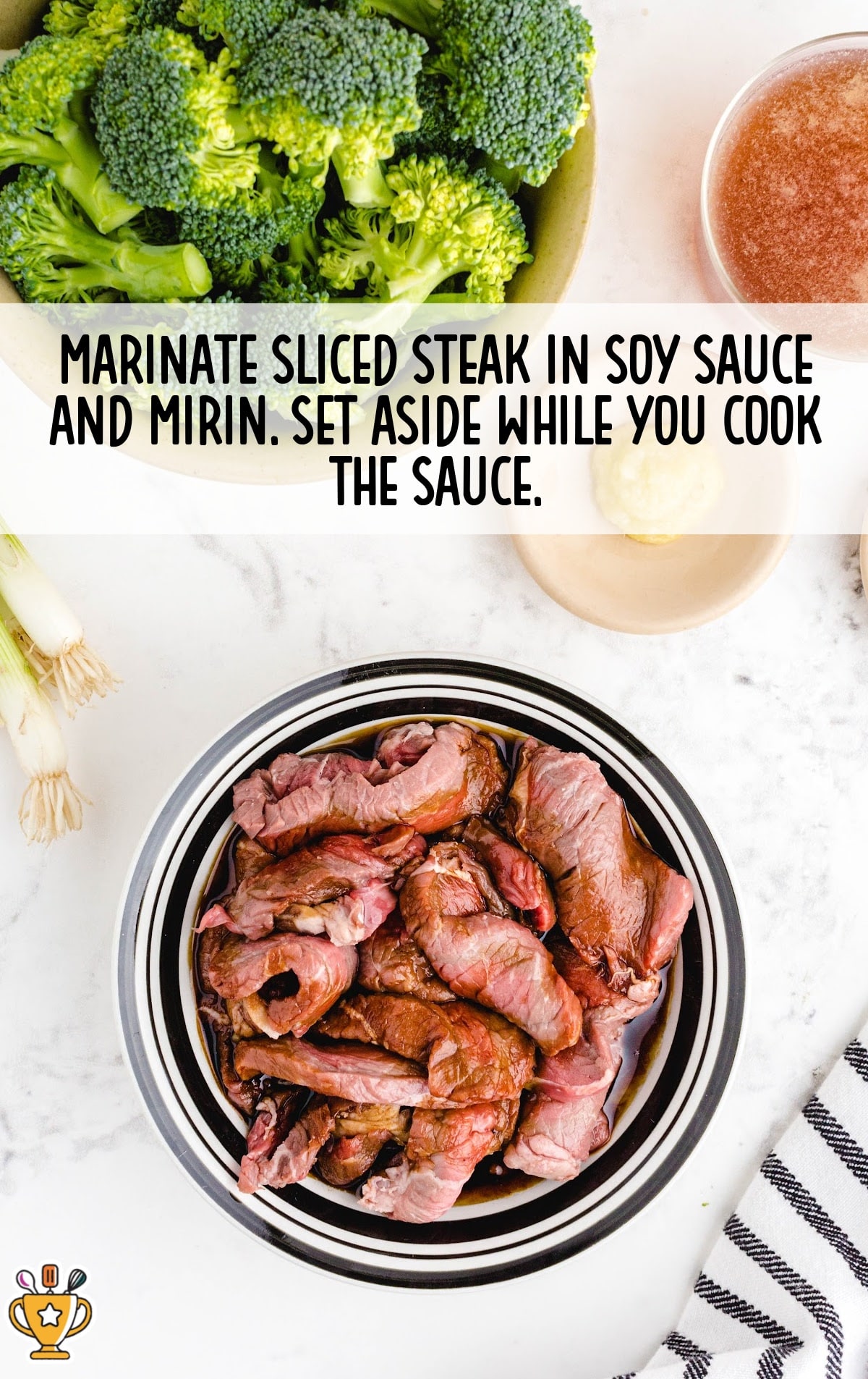 Marinating sliced beef in soy sauce and mirin, fresh broccoli in the background