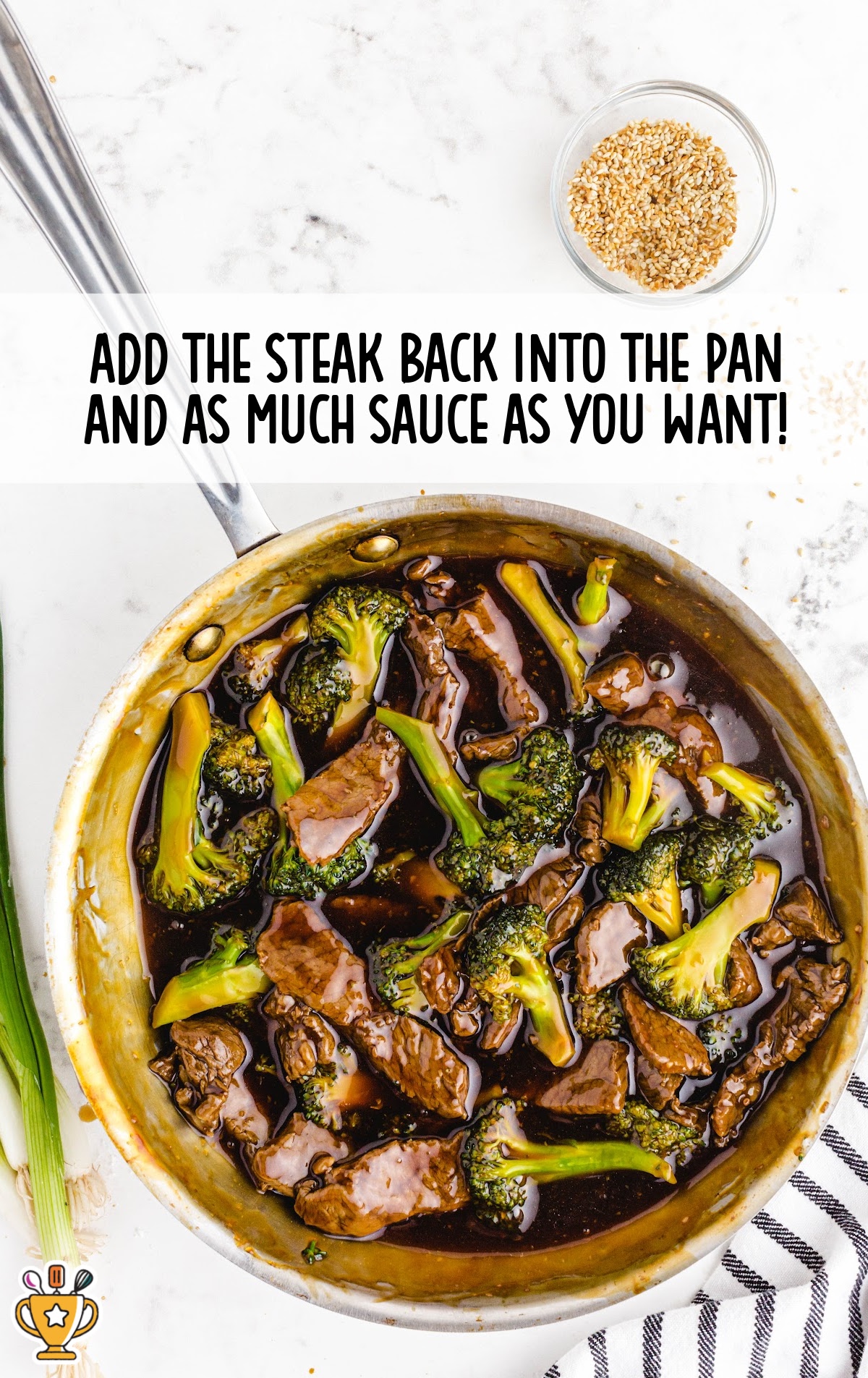 Steak added back into the pan with broccoli and sauce for final mixing, showing rich color and thickened glaze.