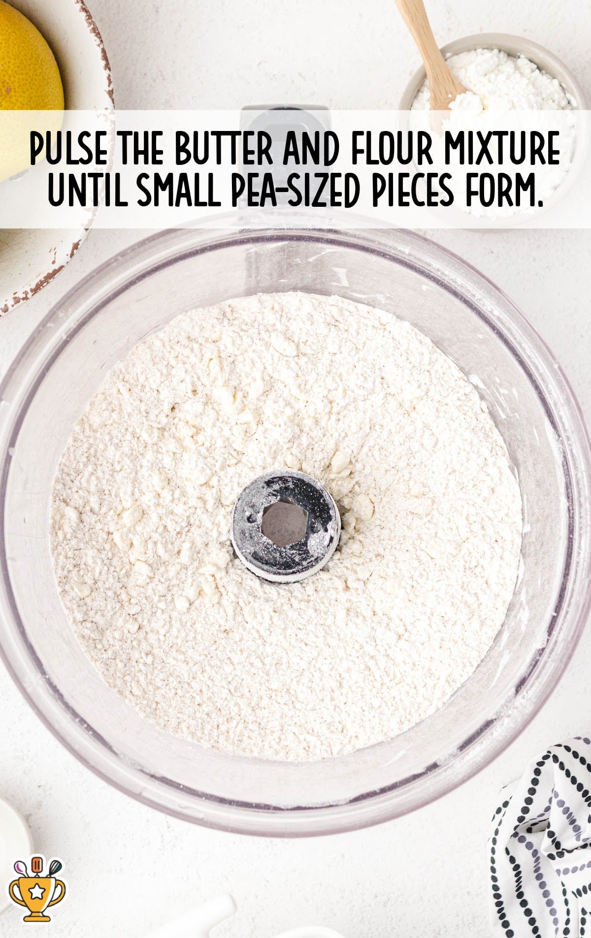 Flour and butter mixture pulsed in a food processor until small pea-sized pieces form, ready for making the pie crust.