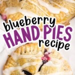 Blueberry hand pies drizzled with icing stacked up, showing juicy blueberry filling with text that says "Blueberry Hand Pies Recipe."