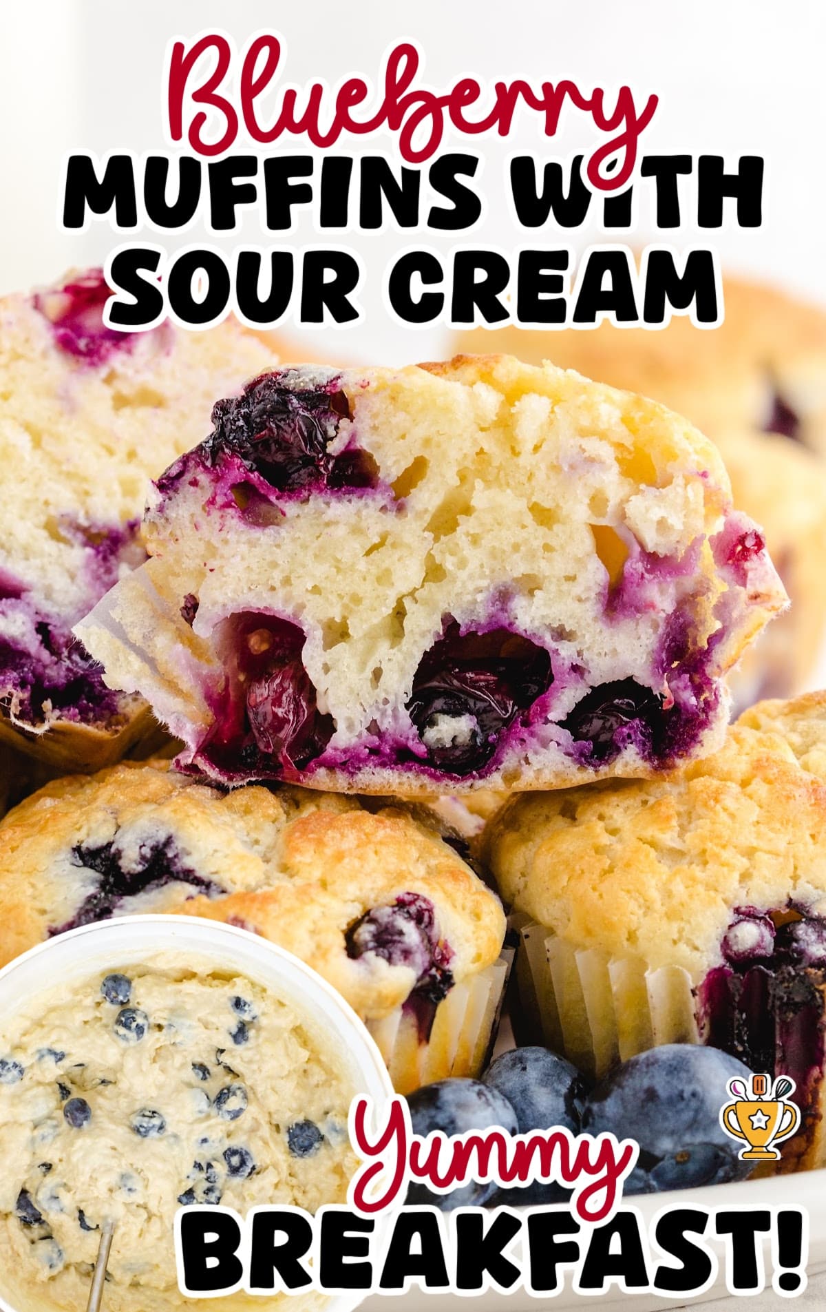 Close-up of moist blueberry muffins, one halved to show the soft, fluffy inside with bursting berries.