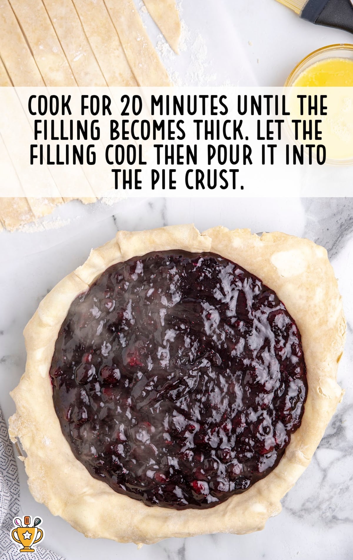 Cooked and thickened blueberry pie filling being poured into a raw pie crust shell, ready for assembly.