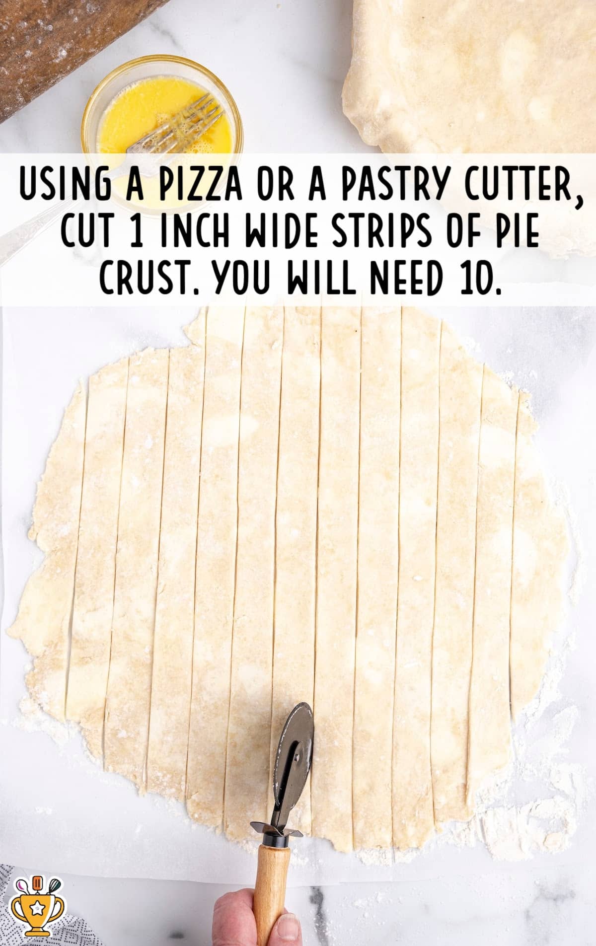 Pie dough rolled out and sliced into even 1-inch wide strips using a pastry cutter.