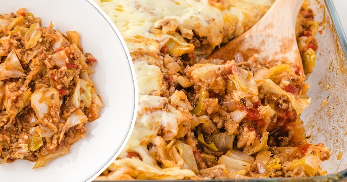 Close-up of cabbage roll casserole in a baking dish with a serving spoon and a plate of the casserole beside it.