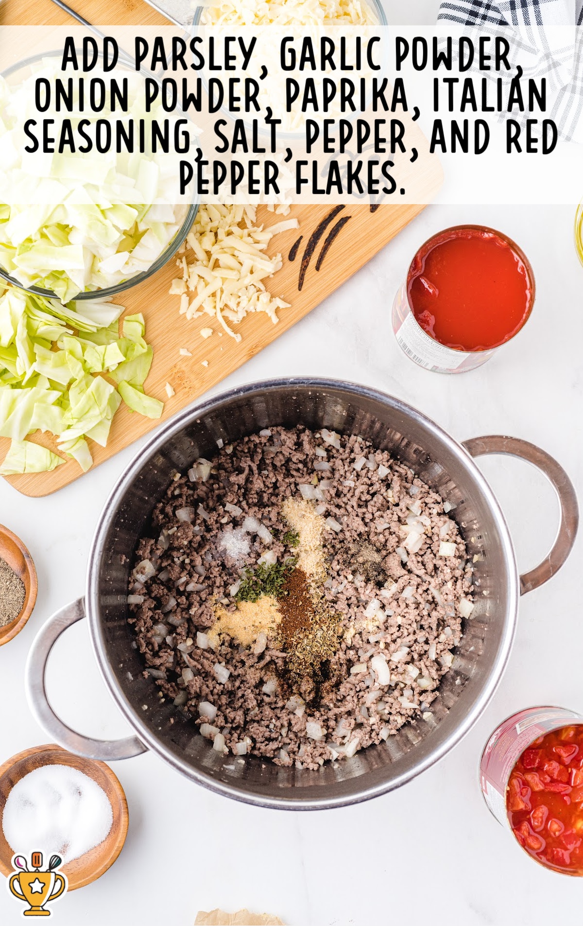 Ground beef mixture in a pot with spices like parsley, garlic powder, paprika, onion powder, salt, pepper, and Italian seasoning.