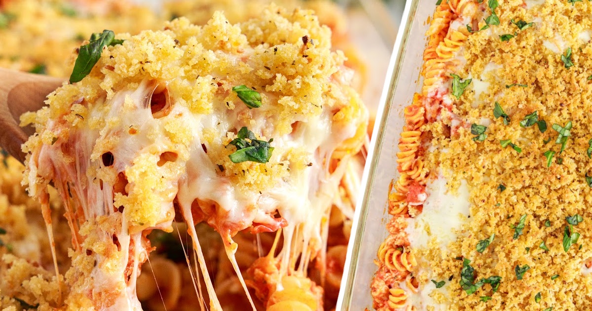 Close-up of a spoonful of Chicken Parmesan Casserole being lifted from the baking dish, with long, melted cheese strands and a golden topping sprinkled with fresh herbs.