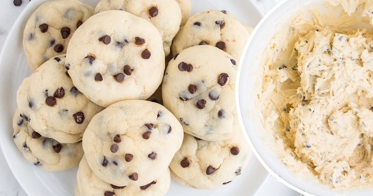 Close-up view of a chocolate chip cheesecake cookie split in half to highlight the rich and moist filling.