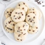 Chocolate chip cheesecake cookie recipe card showing the full baked cookies and a scoop of cookie dough in a white bowl.