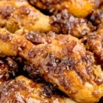 Vertical pin image of sticky Coca-Cola chicken drumsticks with text overlay reading "Coca Cola Chicken - Perfect Family Dinner!" in bold fonts, red and black, above and below the chicken.