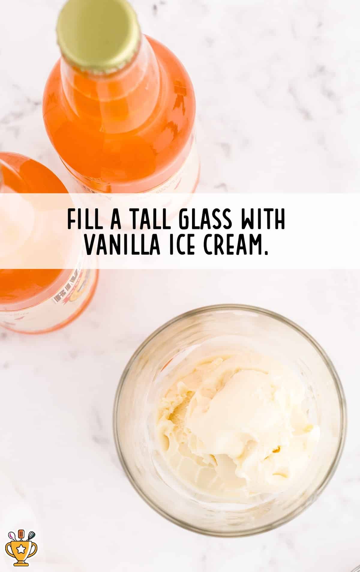 Glass filled with scoops of vanilla ice cream sitting next to bottles of orange soda, labeled with preparation instructions.
