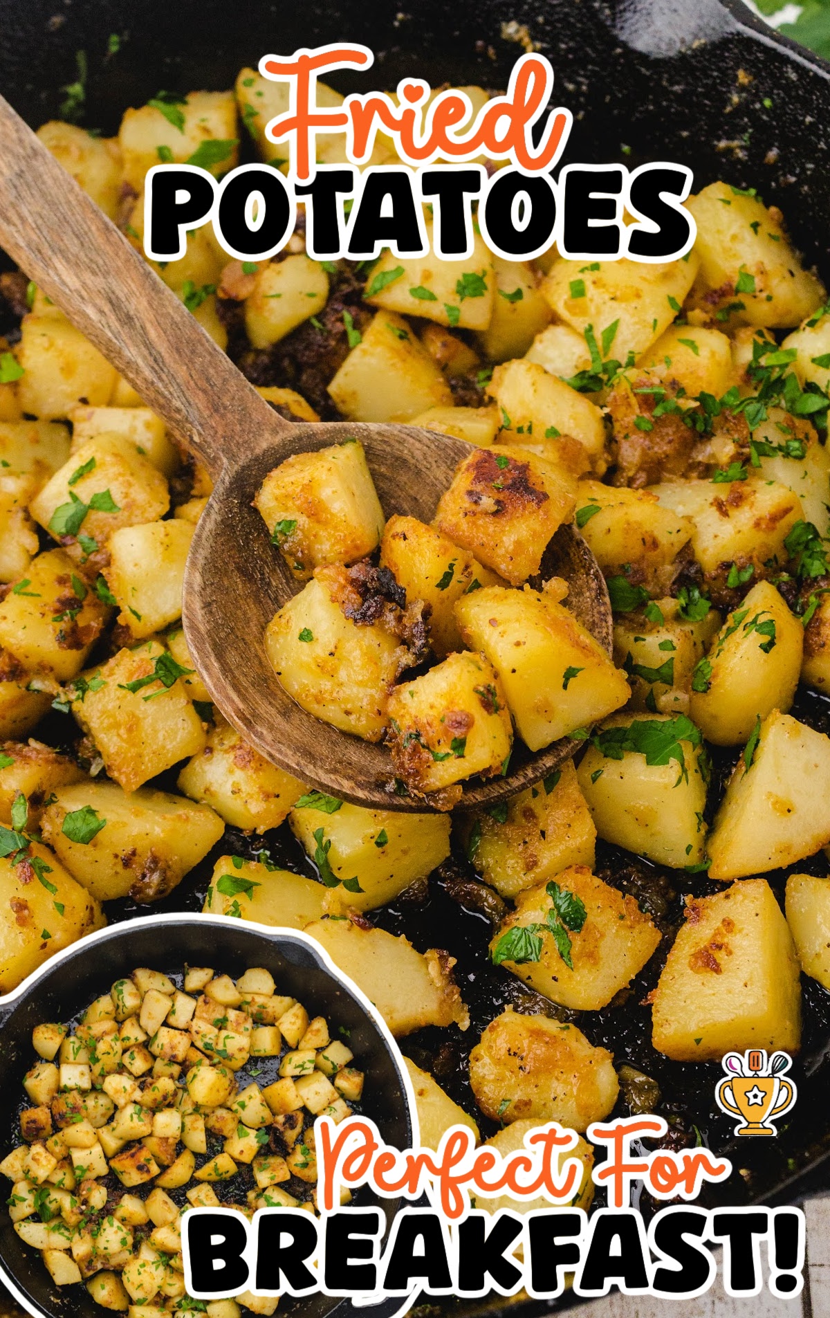 Skillet full of crispy golden potatoes topped with chopped parsley, with a wooden spoon scooping up a hearty bite.
