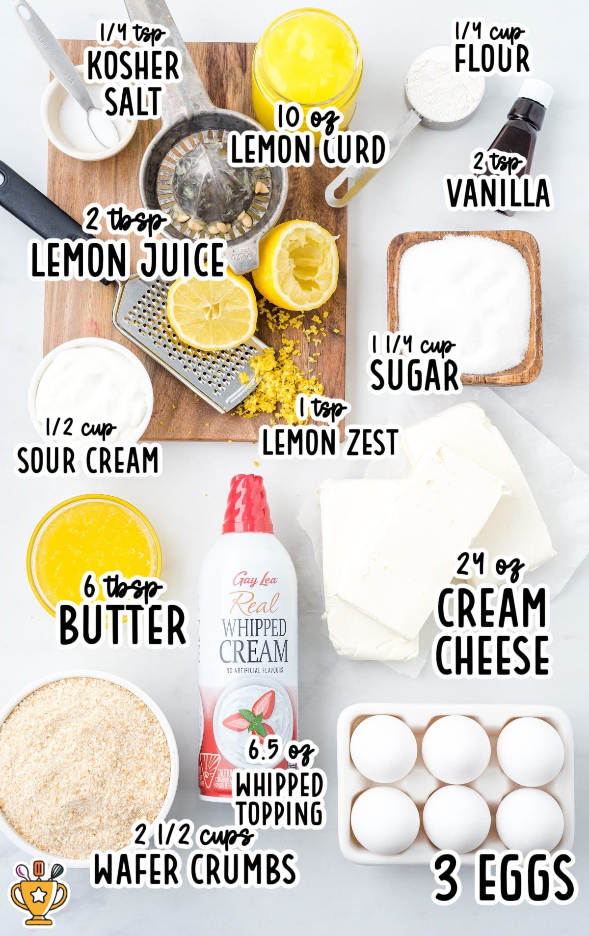 Flat lay of all the ingredients for lemon cheesecake, including cream cheese, sugar, eggs, lemon curd, sour cream, wafer crumbs, and whipped topping.