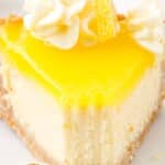 A vertical close-up of a lemon cheesecake slice with whipped cream swirls and lemon wedge, with text that reads “Lemon Cheesecake - Perfect for Company!”