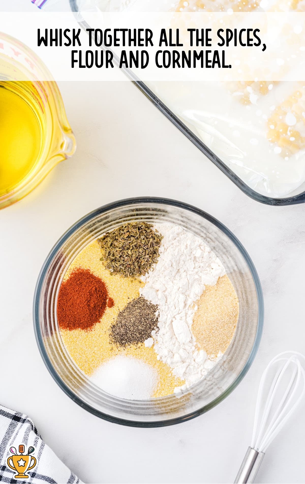 Glass bowl filled with flour, cornmeal, and spices, ready to be mixed for coating the corn.