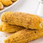 Fried corn on the cob recipe card featuring golden corn and instructions, decorated with comfort food graphics.