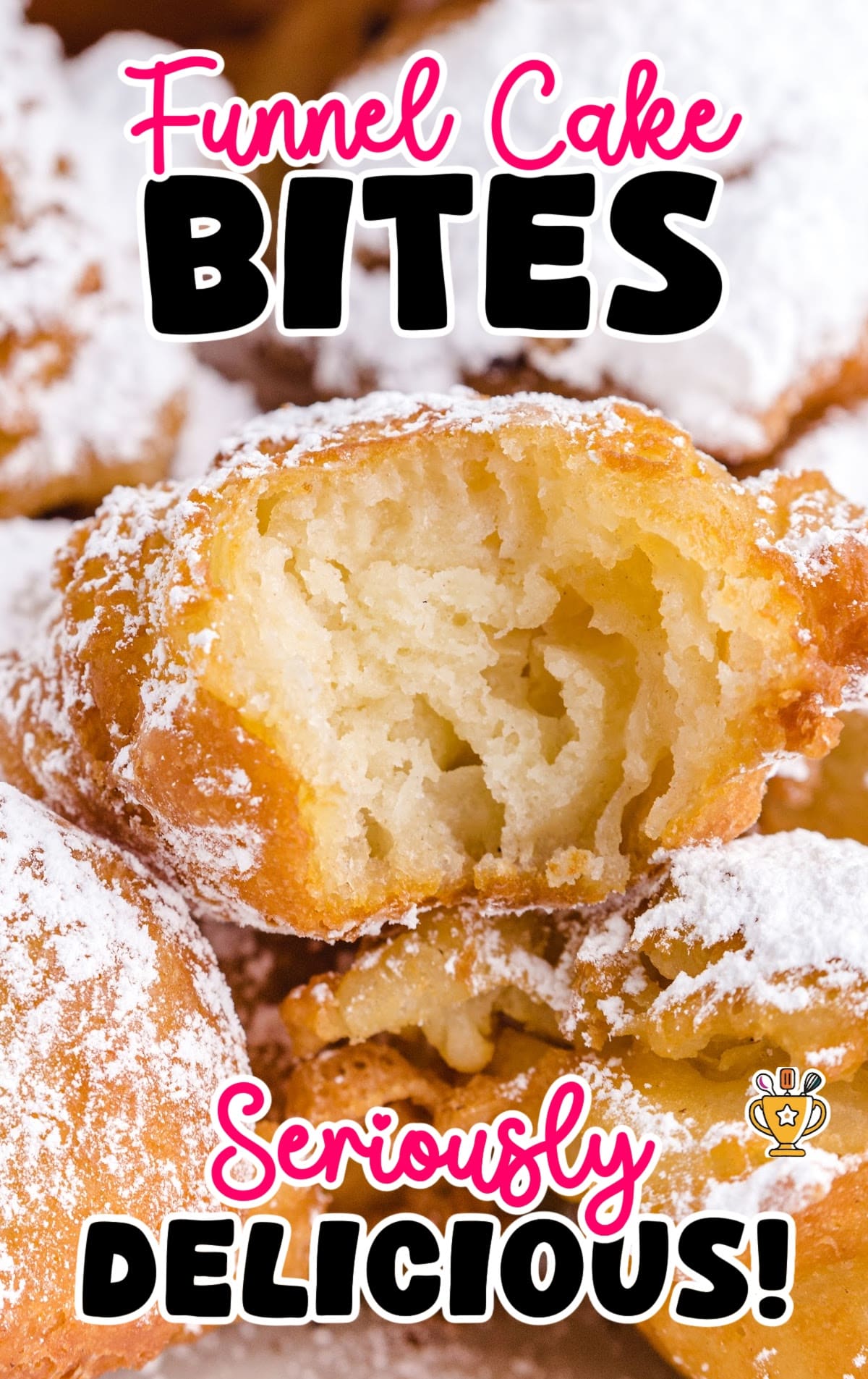 Close-up of golden funnel cake bite with a fluffy interior and dusted with powdered sugar, surrounded by more sugar-coated bites.