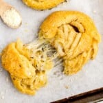 Overhead flat lay of all ingredients including cheese, butter, and crescent rolls.