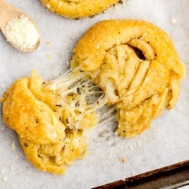 Overhead flat lay of all ingredients including cheese, butter, and crescent rolls.