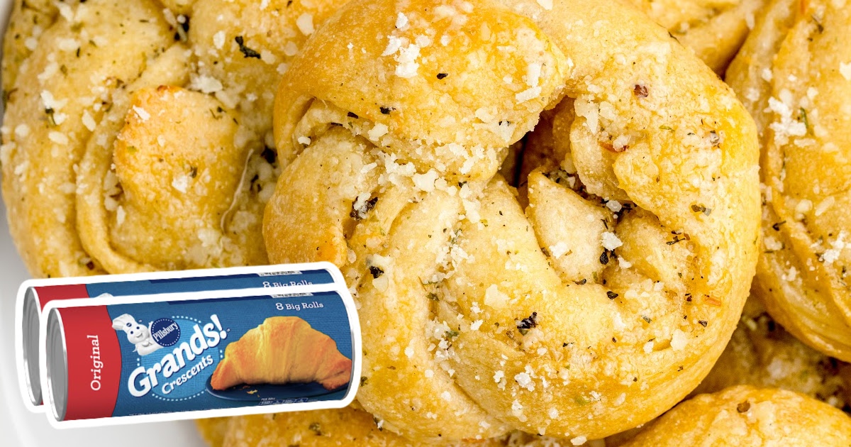 Garlic knot topped with Parmesan next to a Pillsbury Grands crescent roll can.