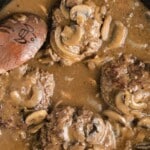 Pinterest graphic showing hamburger steaks in gravy with text overlay &ldquo;The best hamburger steak recipe &ndash; easy comfort food!&rdquo;