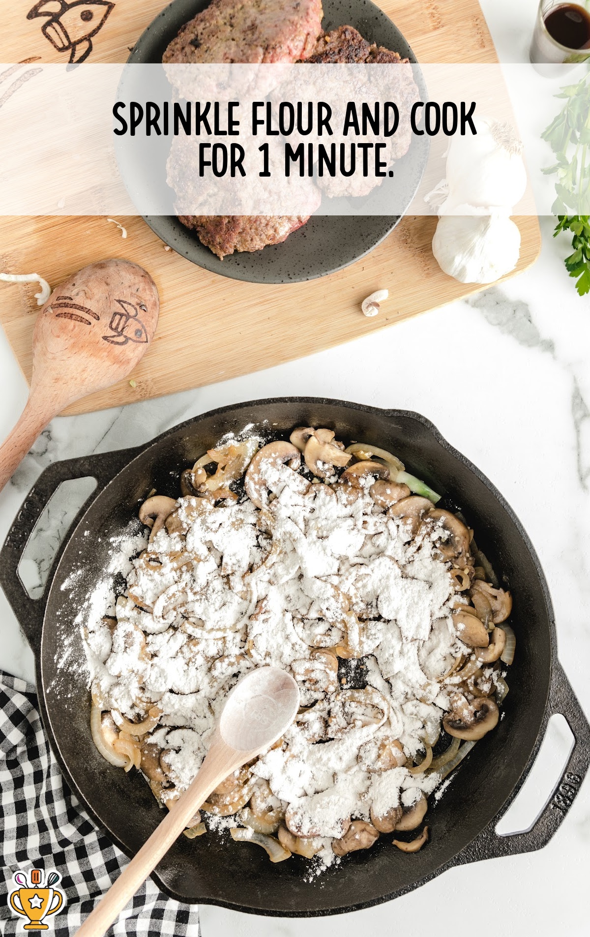Saut&eacute;ed onions and mushrooms in a skillet dusted with flour, ready to thicken into a gravy.