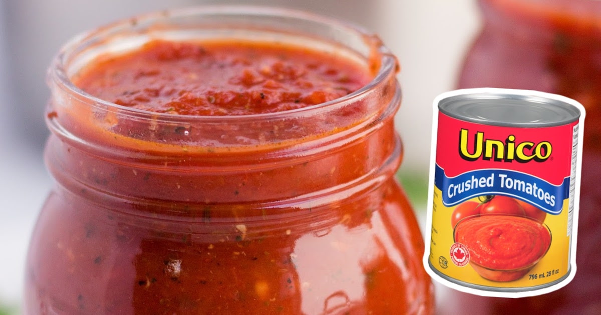 Group of open mason jars filled with homemade tomato sauce, highlighting chunky tomato texture and seasoning.