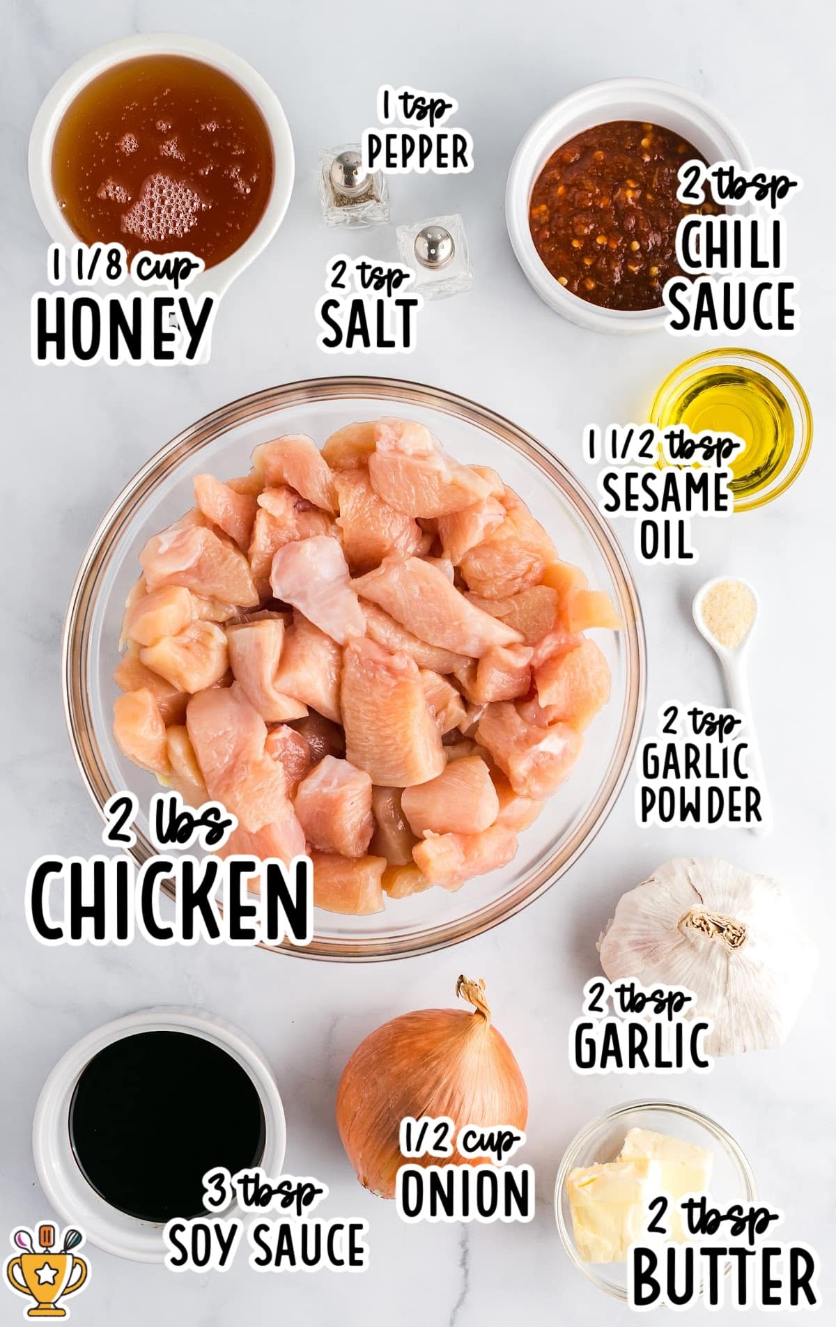 Flat lay of raw ingredients for honey garlic chicken including diced chicken, honey, soy sauce, chili sauce, onion, garlic, sesame oil, butter, and seasonings.
