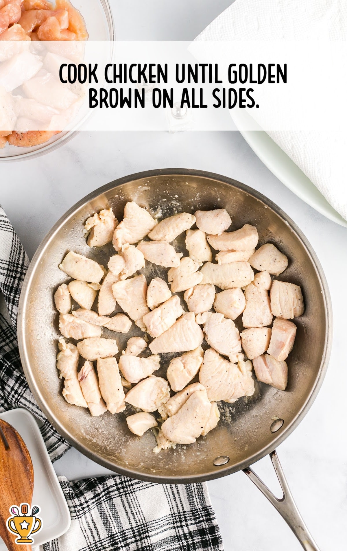 Raw chicken pieces browning in a skillet, showing the first step of cooking for the honey garlic chicken recipe.