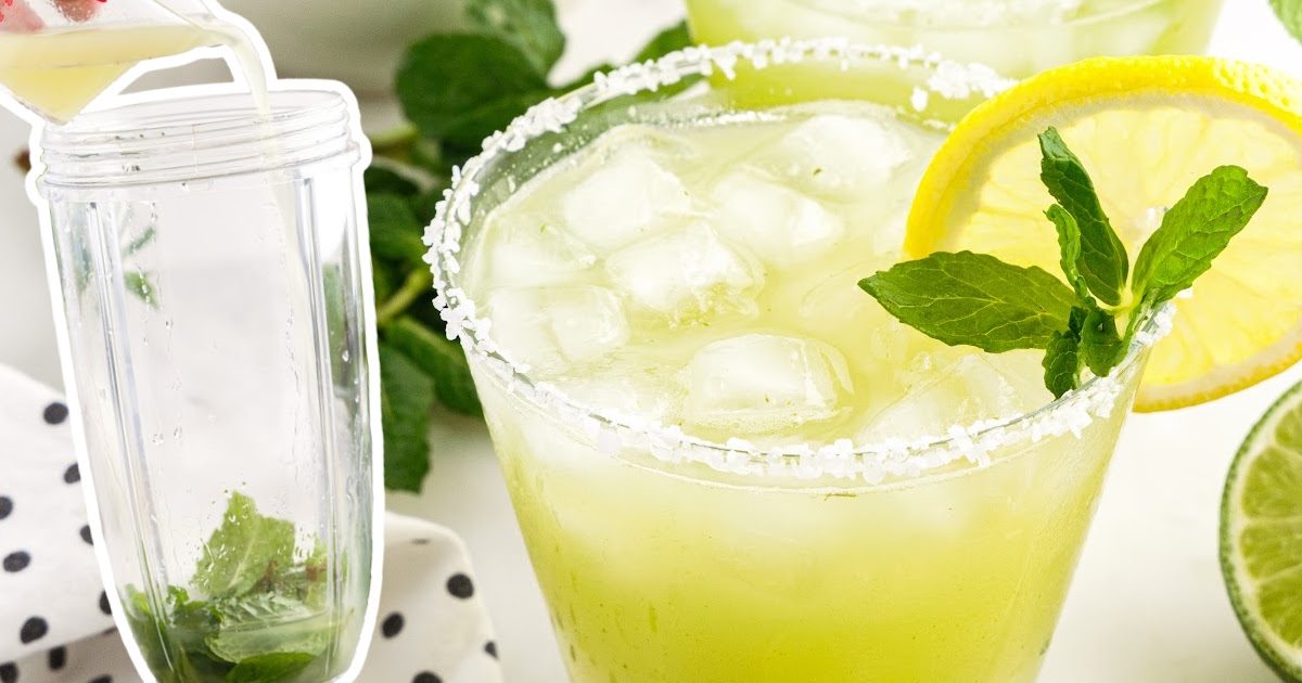 Lemon juice being poured into a blender cup with mint, next to a fresh mint margarita in a salt-rimmed glass garnished with lemon and mint.