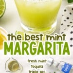 Straight-on shot of mint margarita in front of a tequila bottle, with lemon and mint garnish and lime wedge on the side.