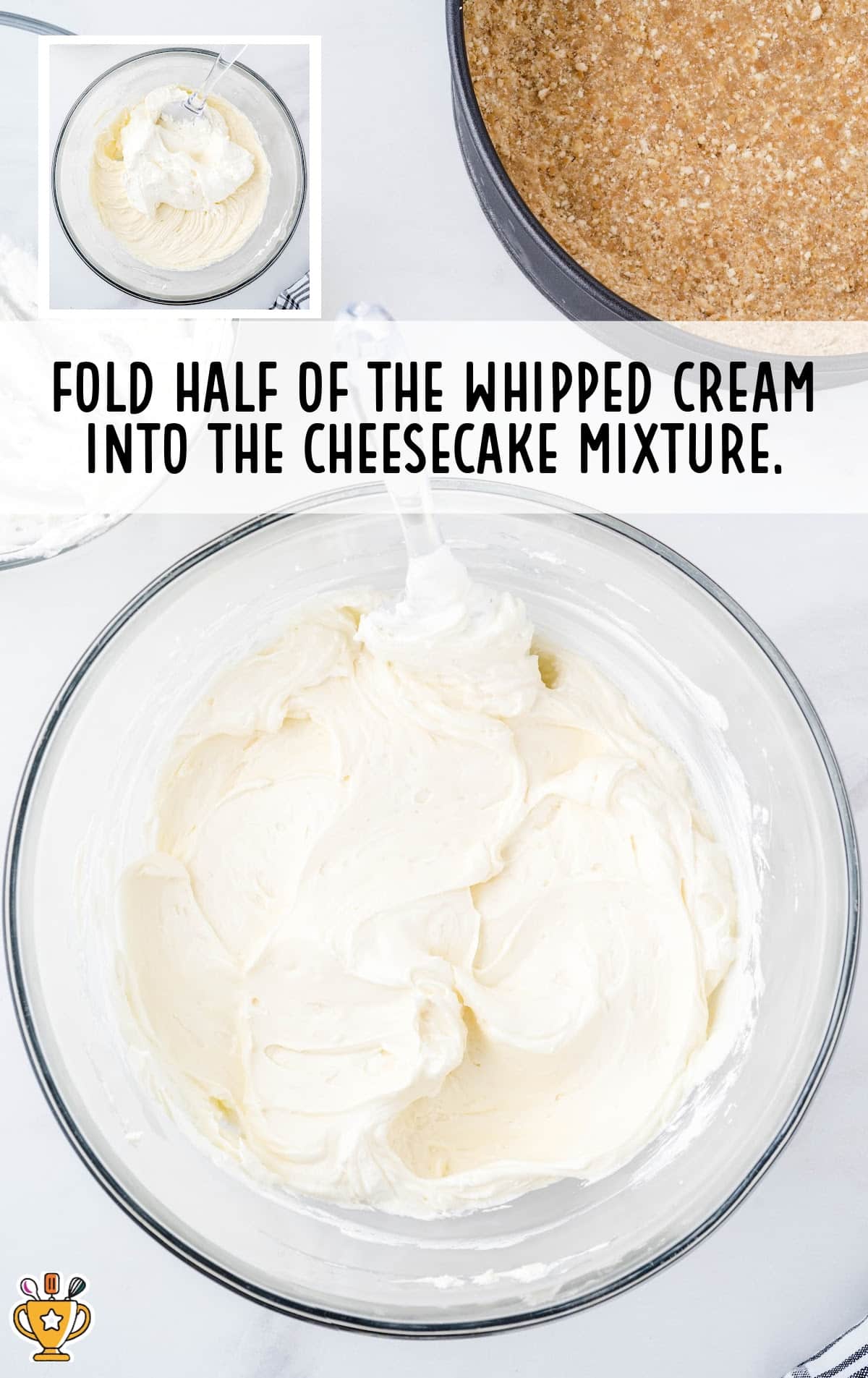 A bowl of creamy cheesecake filling after folding in whipped cream, ready to be layered into the crust. A springform pan appears in the corner.