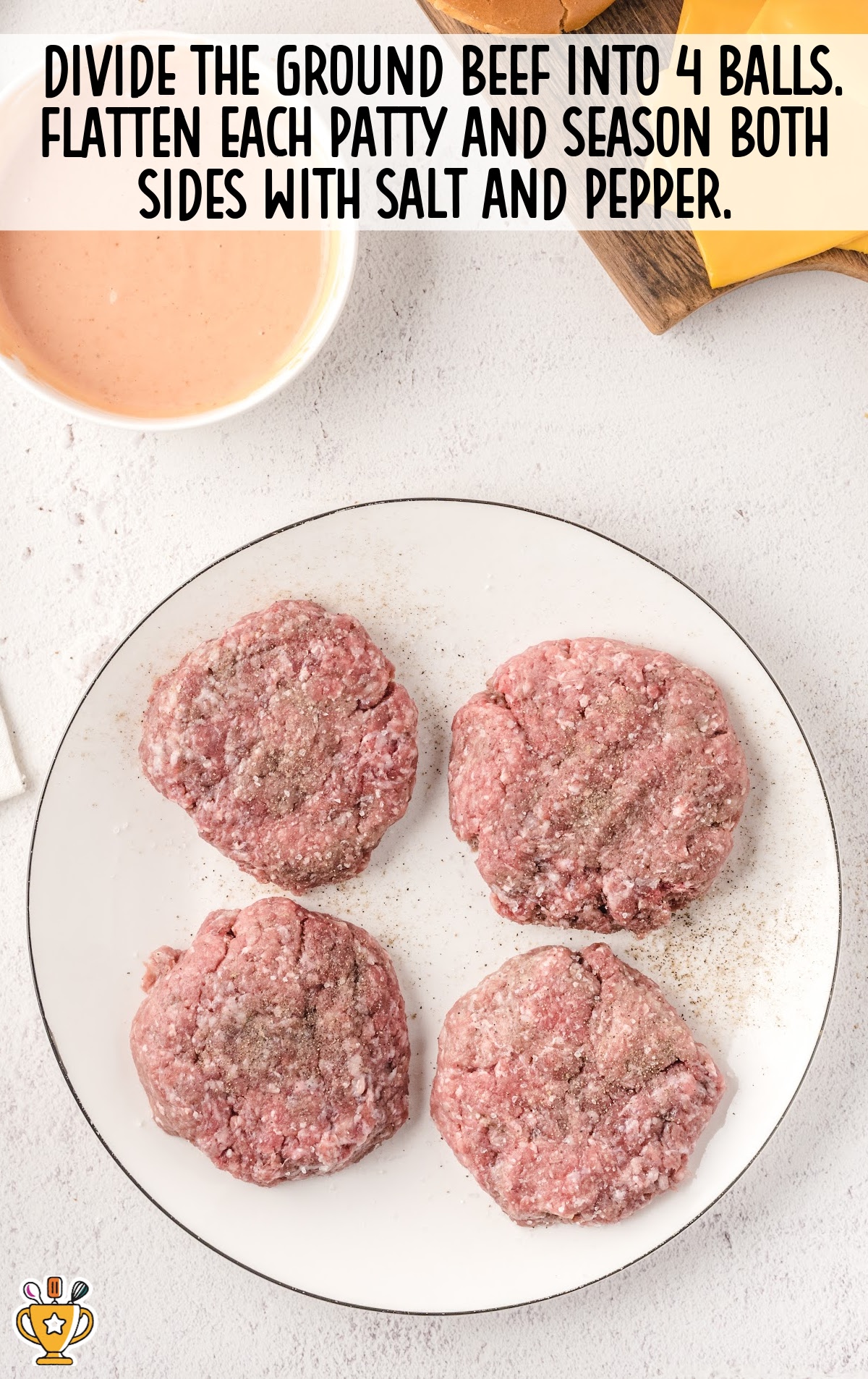 Four seasoned raw burger patties flattened on a white plate, ready to be cooked for an Oklahoma-style burger.
