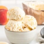 Flat lay of measured ingredients for homemade peach ice cream, labeled clearly on a white background.