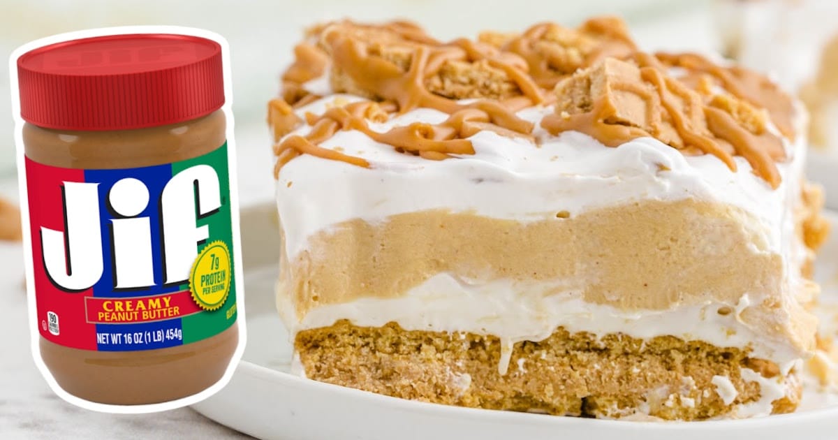 Slice of peanut butter lasagna on a plate with creamy layers and cookie topping, next to a Jif peanut butter jar.