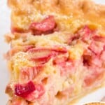Vertical pin with a close-up slice of rhubarb custard pie and text that reads “Rhubarb Custard Pie – Baked in a Flaky Pie Crust!”