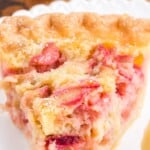 Vertical Pinterest pin featuring a slice of rhubarb custard pie on a plate with text overlay that says “Rhubarb Custard Pie – Creamy and Delicious.”