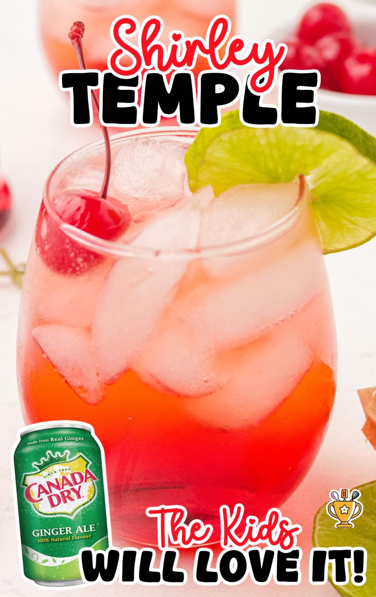 Close-up of a Shirley Temple drink served in a mason jar with ice, maraschino cherries on a skewer, a lime wheel garnish, and a polka-dot straw.