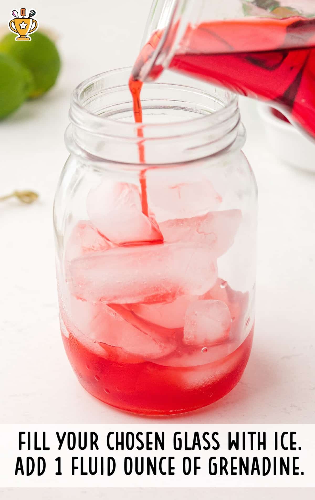 Grenadine being poured over ice into a mason jar as the first step in preparing a Shirley Temple drink. Text instruction overlay at the bottom