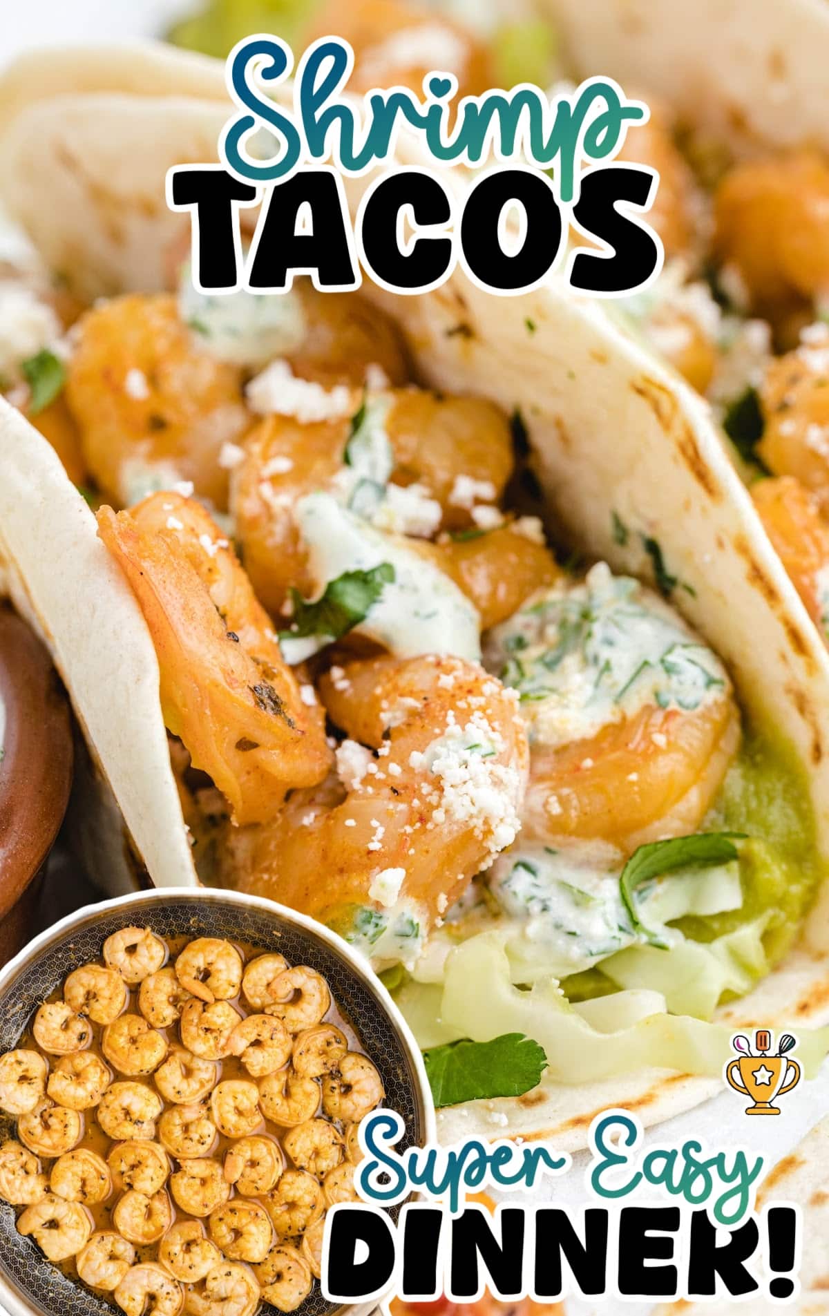 Three shrimp tacos lined up and overflowing with spiced shrimp, shredded cabbage, guacamole, and cilantro crema, garnished with cotija cheese and fresh cilantro.