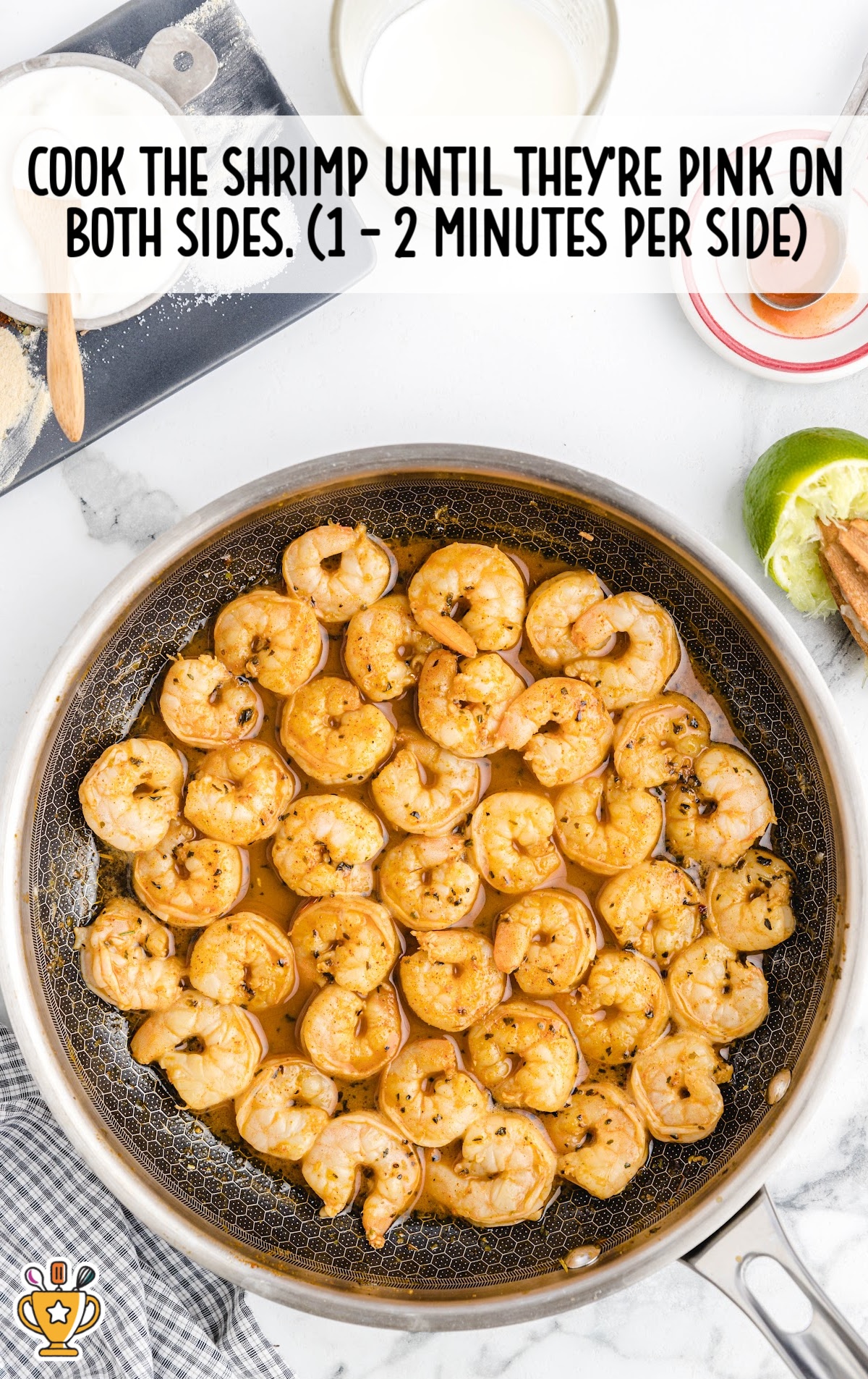 Pan of shrimp cooking until pink, surrounded by prep items like lime, garlic, and a mixing bowl, with instructions to cook shrimp 1–2 minutes per side.