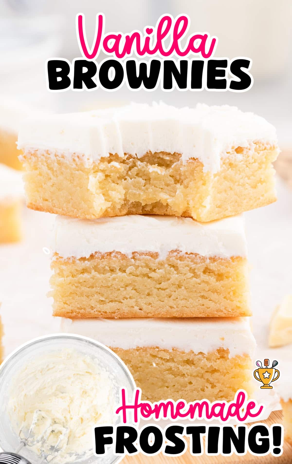 Stack of three golden vanilla brownies topped with thick homemade white frosting, highlighting a soft and moist texture.